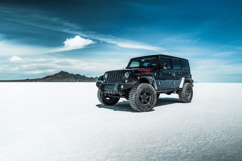 off road car in the desert on white sand