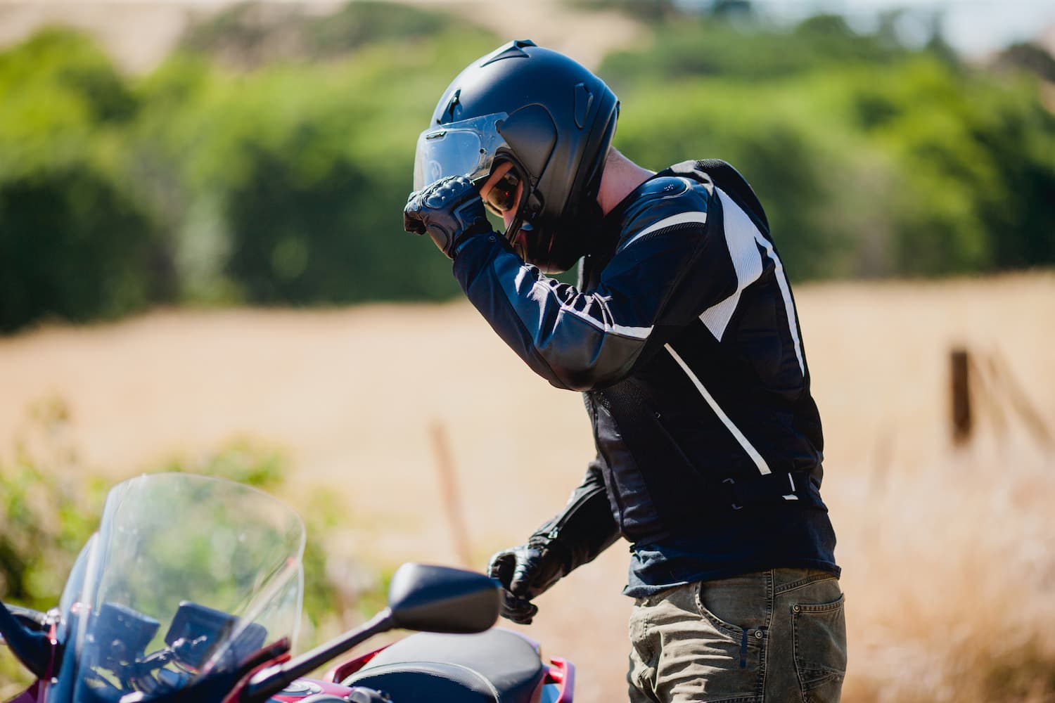 Man standing next to motorcycle