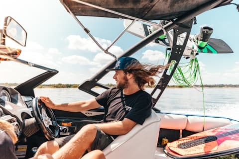 person riding a boat on a lake